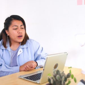 Lady sitting looking at open laptop